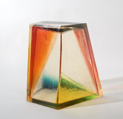 Prism shape of clear plastic with brightly colored triangles on various sides.