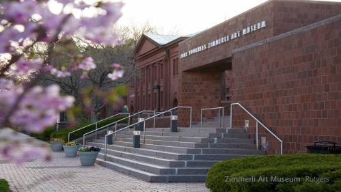 Photo of museum exterior with cherry blossoms at left
