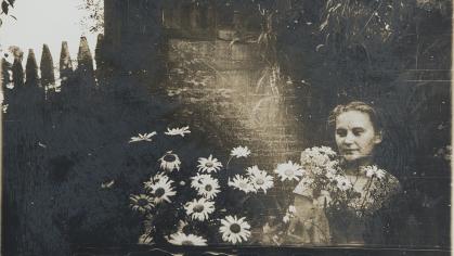 Sepia photography with a woman in a field of flowers