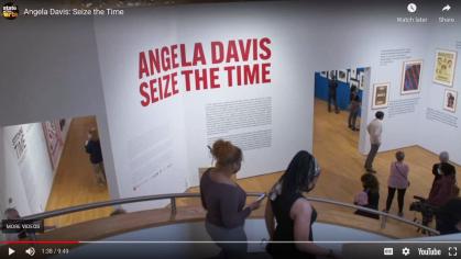 still image of visitors walking down steps in the museum