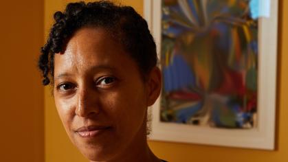 close up of African American woman's face with painting in background
