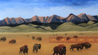 Landscape painting with brown and green earth and gray-blue mountains in the background. On the land is a herd of buffalo grazing.
