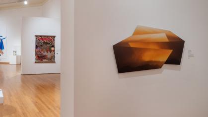gallery with two artworks hanging in the walls
