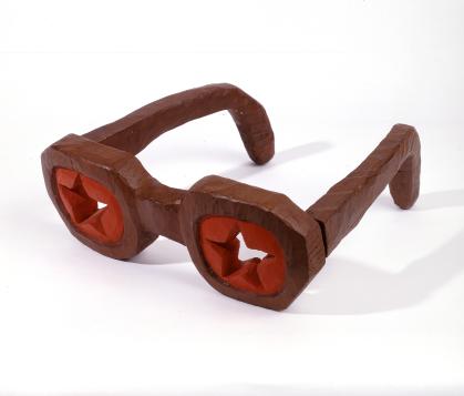 Carved glasses made from wood with each "lens" painted red with a star shape cut-out