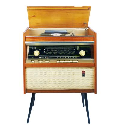 Stereo with record player; housing is stained wood with blue legs in mid-century modern style