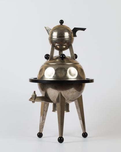 Samovar (hot beverage dispenser) with shape inspired by space satellites; body is silver-colored metal with black accents