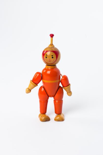 Wooden toy of astronaut in orange space suit; limbs are jointed for repositioning