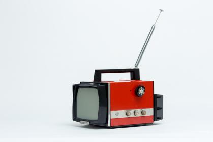 Portable television with handle and red plastic body