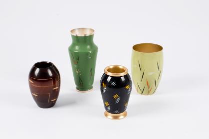Four small vases of varying shapes and decorations; decoration is relatively simple with repeated patterns