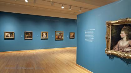 Photo of European gallery with portraits and blue painted walls