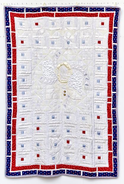 Quilt with image of Abraham Lincoln in white fabrics surrounded by red and blue with star pattern borders.