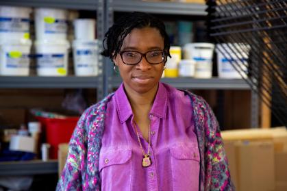 Portrait of Jennifer Mack-Watkins, a Black woman wearing a purple shirt and glasses