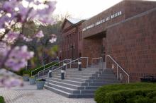 Exterior building view of Zimmerli Art Museum with pink flowering trees