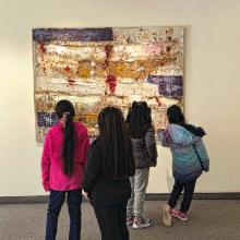 children standing in front of Joan Snyder painting in gallery