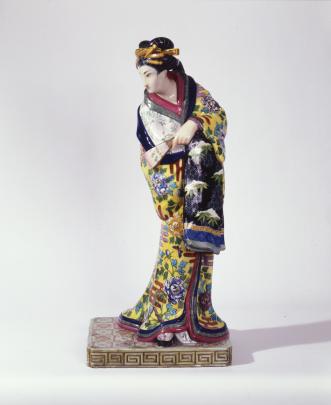 Porcelain statue of Japanese woman wearing traditional kimono and holding fan