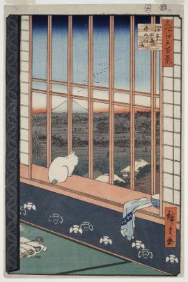 A cat looks out at the landscape below from the window of a nicely decorated Japanese room; Mt Fuji is in the distance