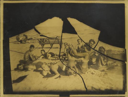 Photo from broken negative of group of people on a beach