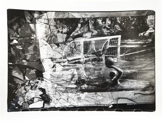 Photo of water polo game seen through shattered glass