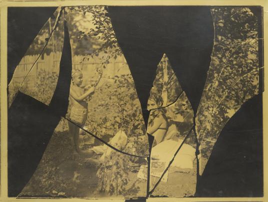 Photo from broken, incomplete negative of children playing in a garden