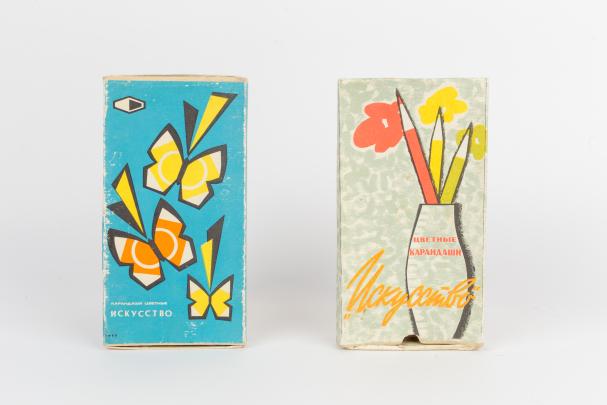 Two color pencil packages; one with butterfly design, one with vase holding flowers and pencils