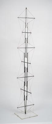 Tall and thin sculpture made of metal rods and wire; wires form diamond shapes