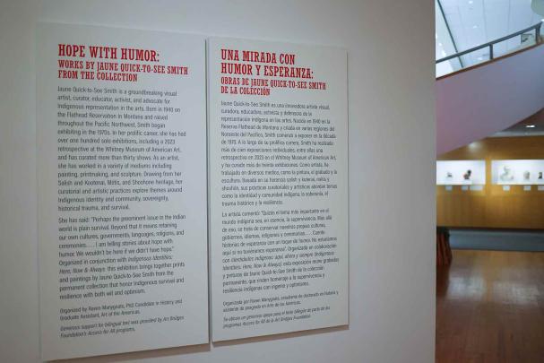 A gallery wall inside the Zimmerli Art Museum features English and Spanish text.