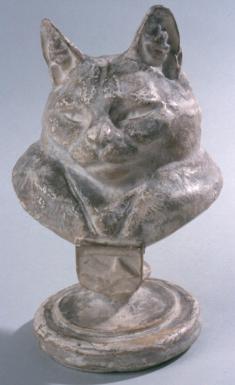 Plaster statue bust of a cat with a bemused expression